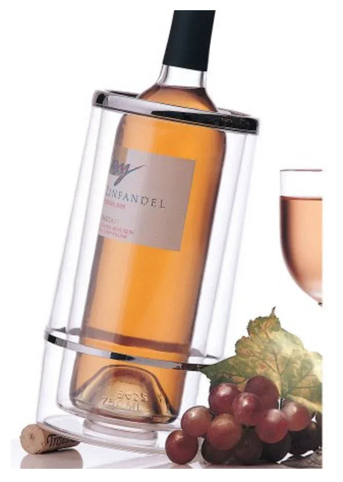 Wine bottle in clear chiller, glass of rosé, grape cluster and leaf on table